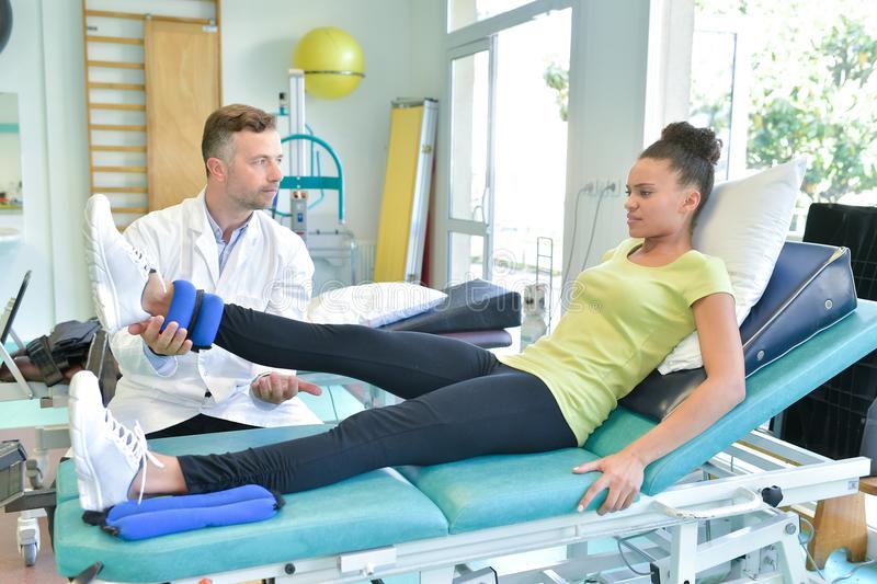 doctor stretching women leg physiotherapy session doctor stretching woman leg physiotherapy session 103746386 1